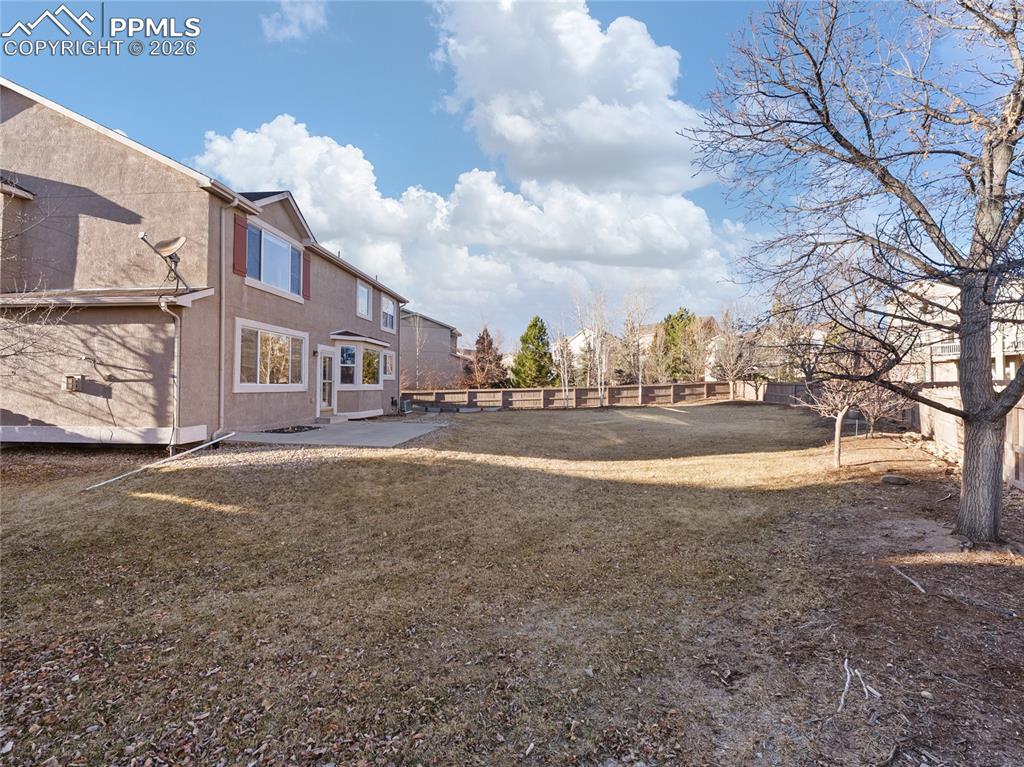 Image 43 of 46: Fenced backyard featuring a patio