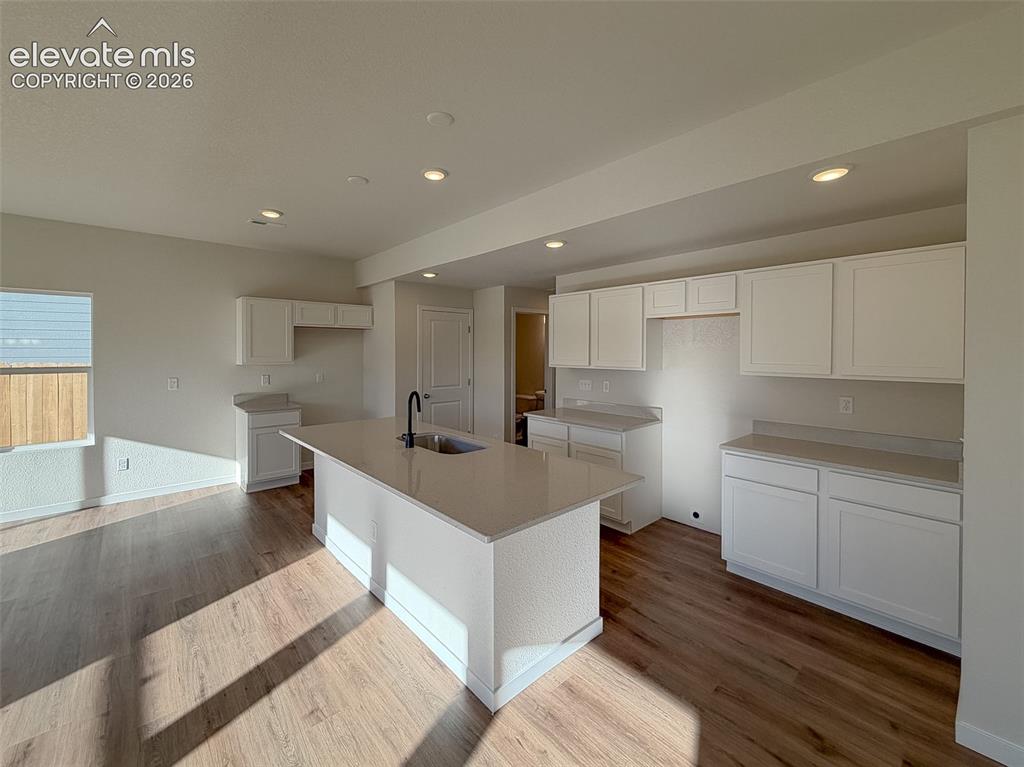 Image 9 of 34: Open-concept kitchen featuring an expansive center island with an integrate