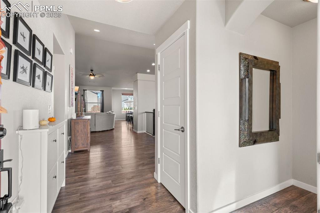 Image 3 of 48: Hall featuring dark wood finished floors and recessed lighting