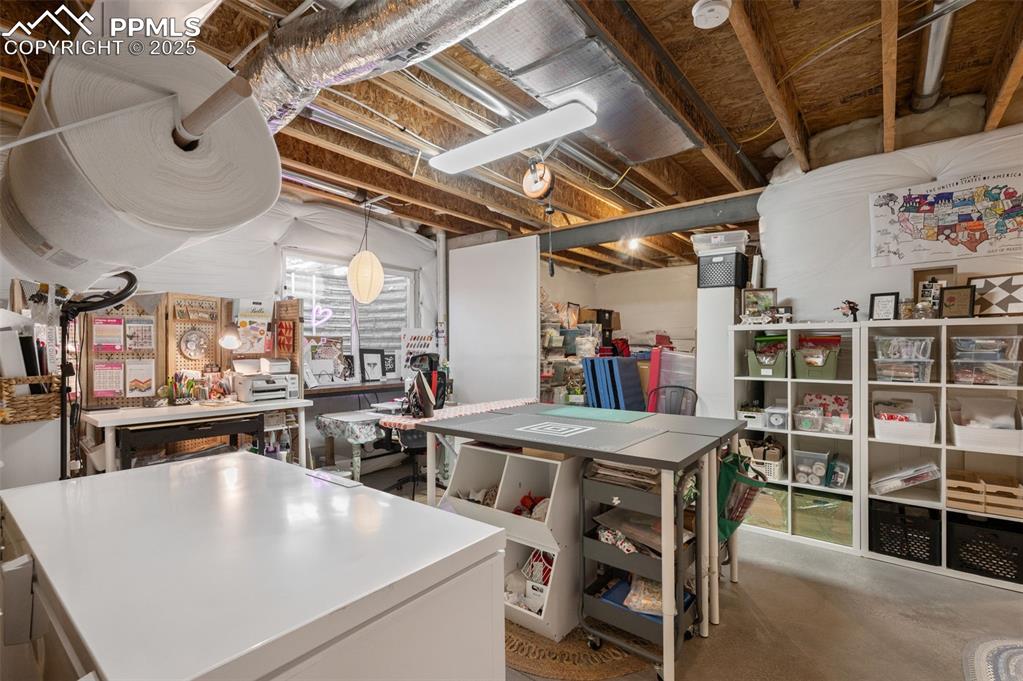 Image 33 of 48: Unfinished below grade area with a workshop area