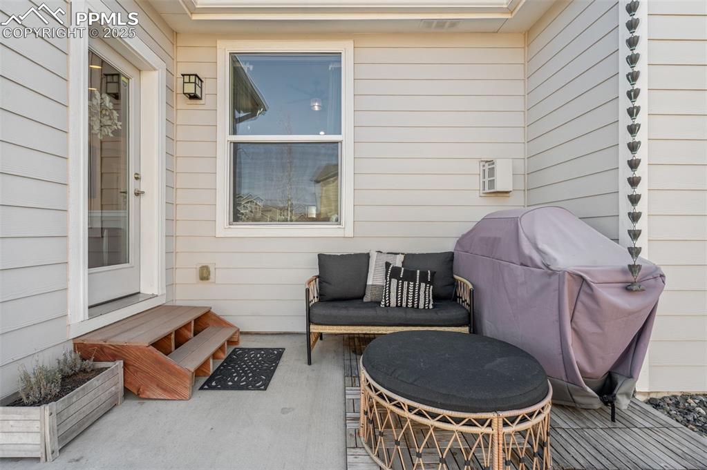 Image 36 of 48: View of patio featuring grilling area and outdoor lounge area