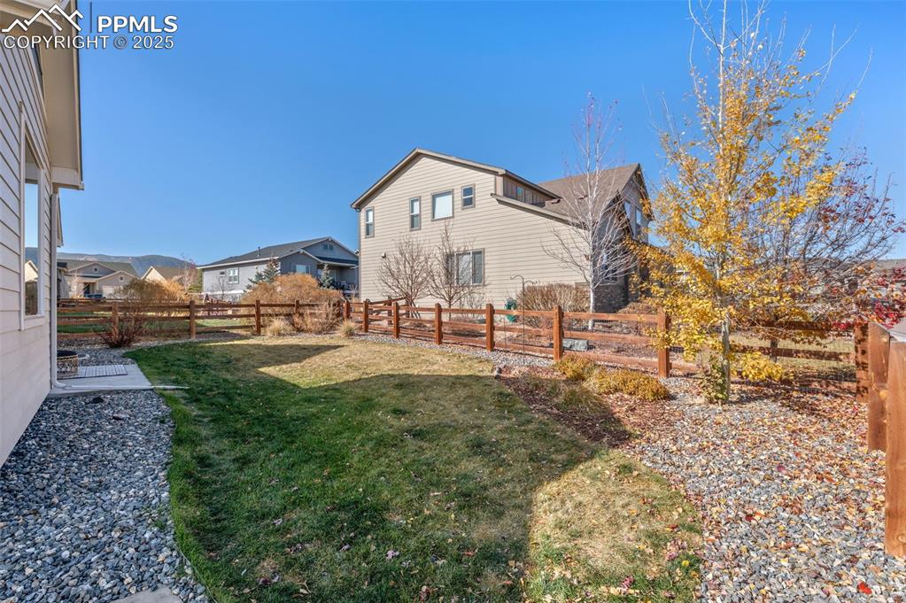 Image 38 of 48: Fenced backyard featuring a residential view