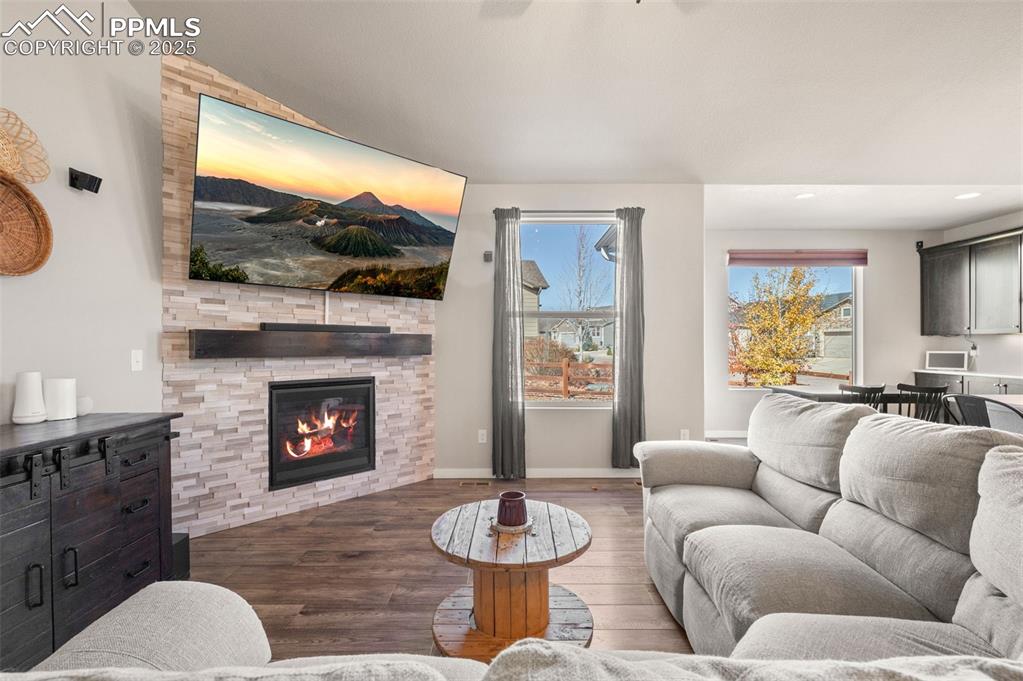 Image 4 of 48: Living area featuring wood finished floors, healthy amount of natural light