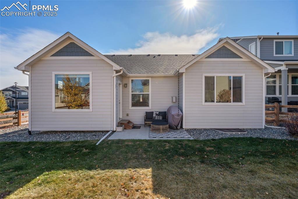 Image 41 of 48: Rear view of house featuring a patio area and roof with shingles