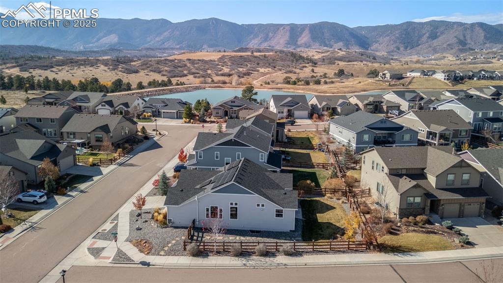 Image 42 of 48: Aerial perspective of suburban area featuring a water and mountain view