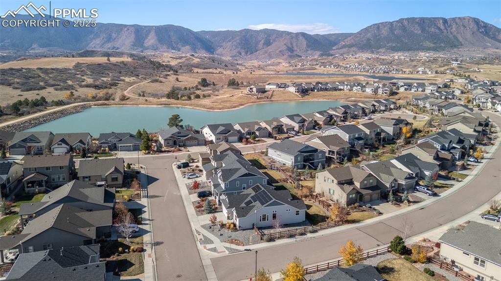 Image 43 of 48: Aerial perspective of suburban area with a water and mountain view