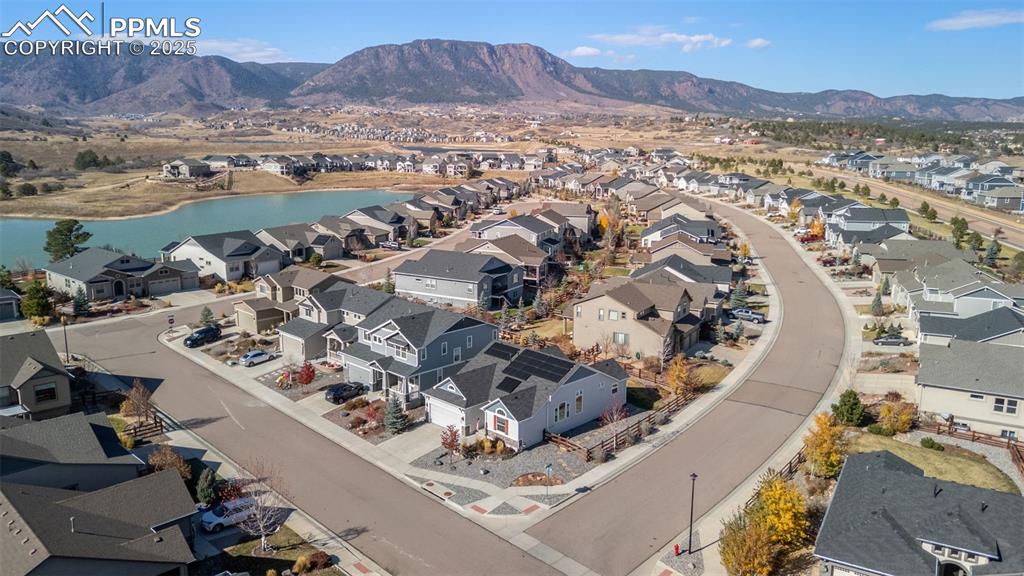 Image 44 of 48: Aerial perspective of suburban area featuring a water and mountain view