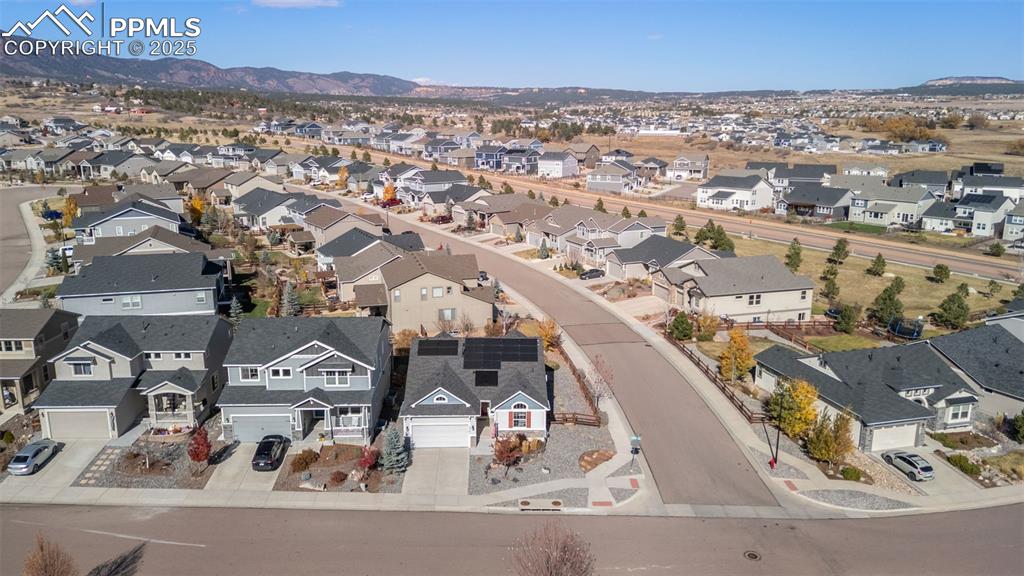 Image 45 of 48: Aerial perspective of suburban area featuring mountains