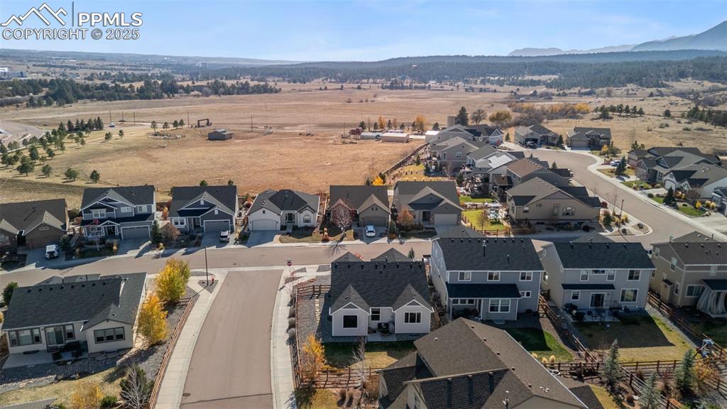 Image 47 of 48: Aerial view of residential area with mountains