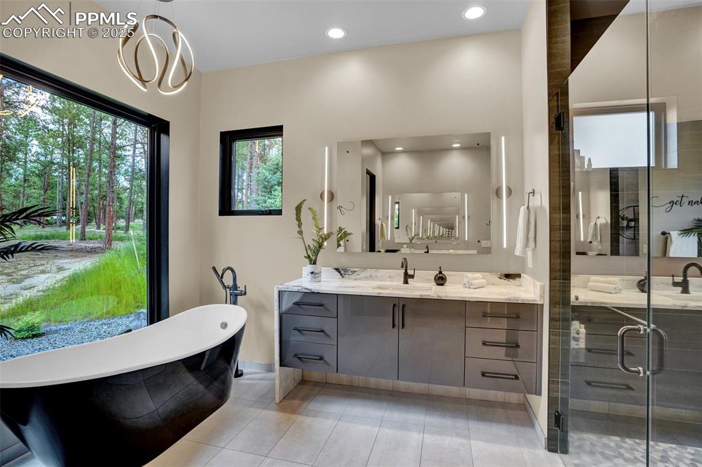 Image 11 of 36: Primary bath has 2 separate vanites, 2 person shower and a soaking tub!