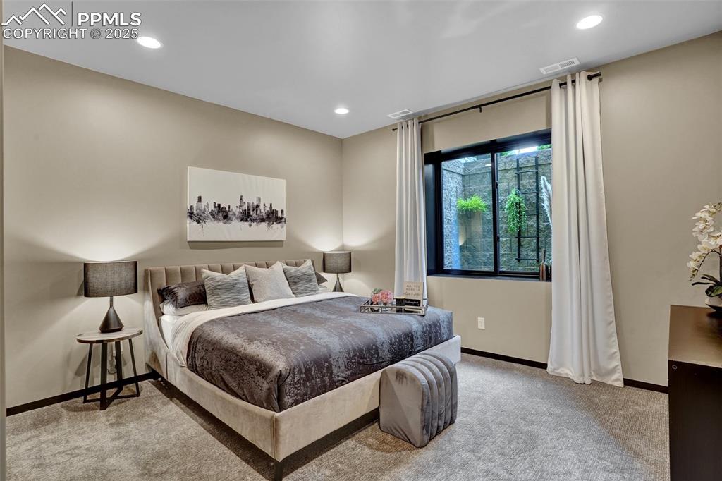 Image 15 of 36: Large lower bedroom adjoins the 3/4 bath.