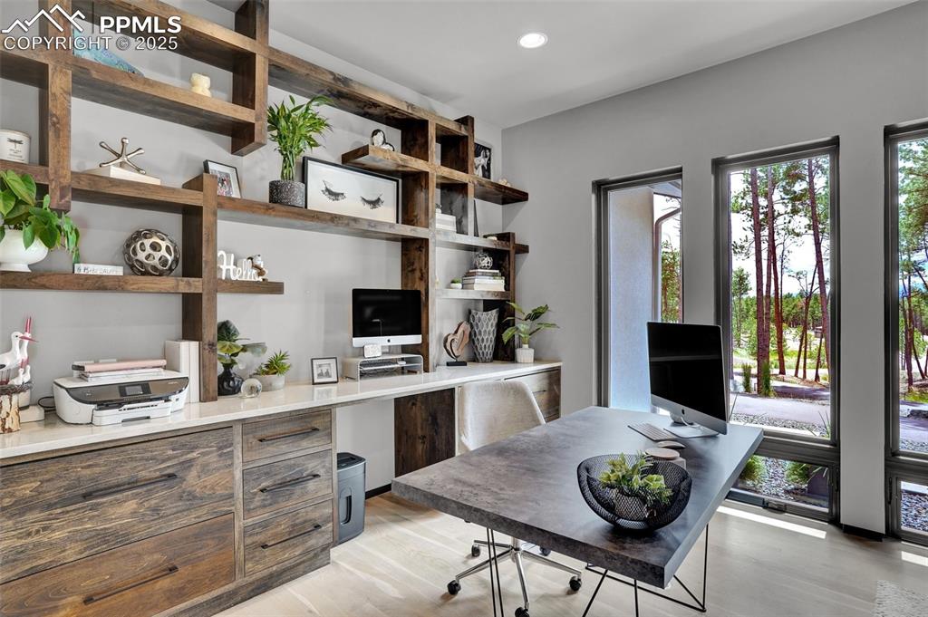 Image 9 of 36: Built in Shelves, coutnertops and filing drawer. Wood flooring continues in