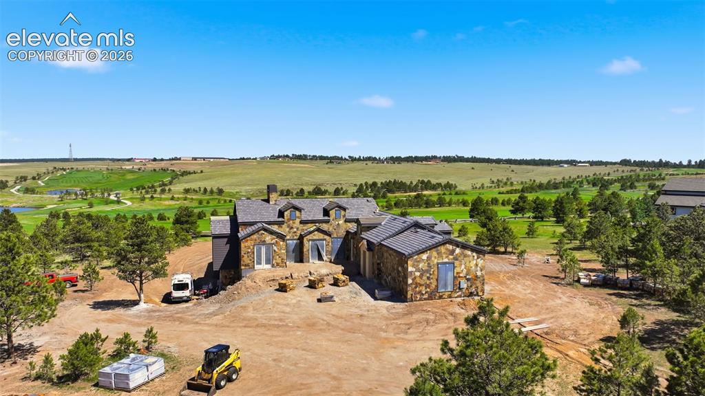 Image 3 of 5: Stone exterior residence featuring multiple dormers, a multi-pitch roofline