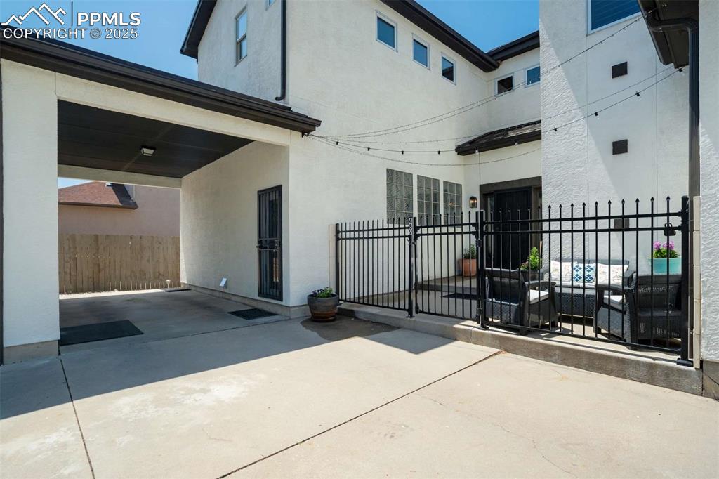 Image 2 of 50: Back of house featuring a patio area and stucco siding