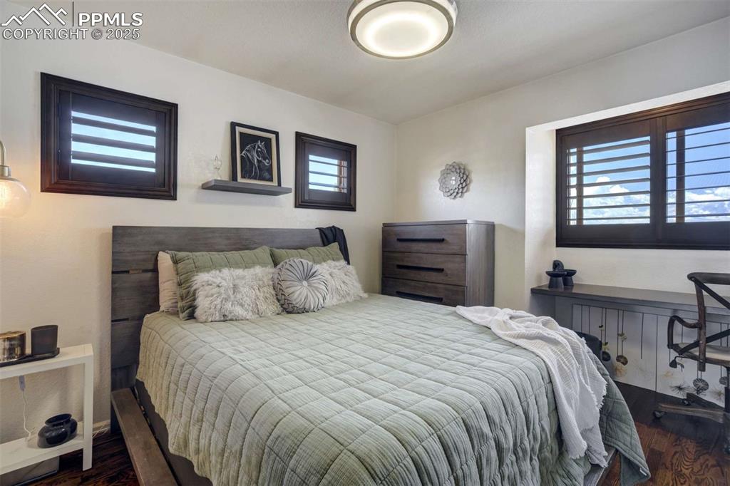 Image 26 of 50: Bedroom with dark wood-type flooring
