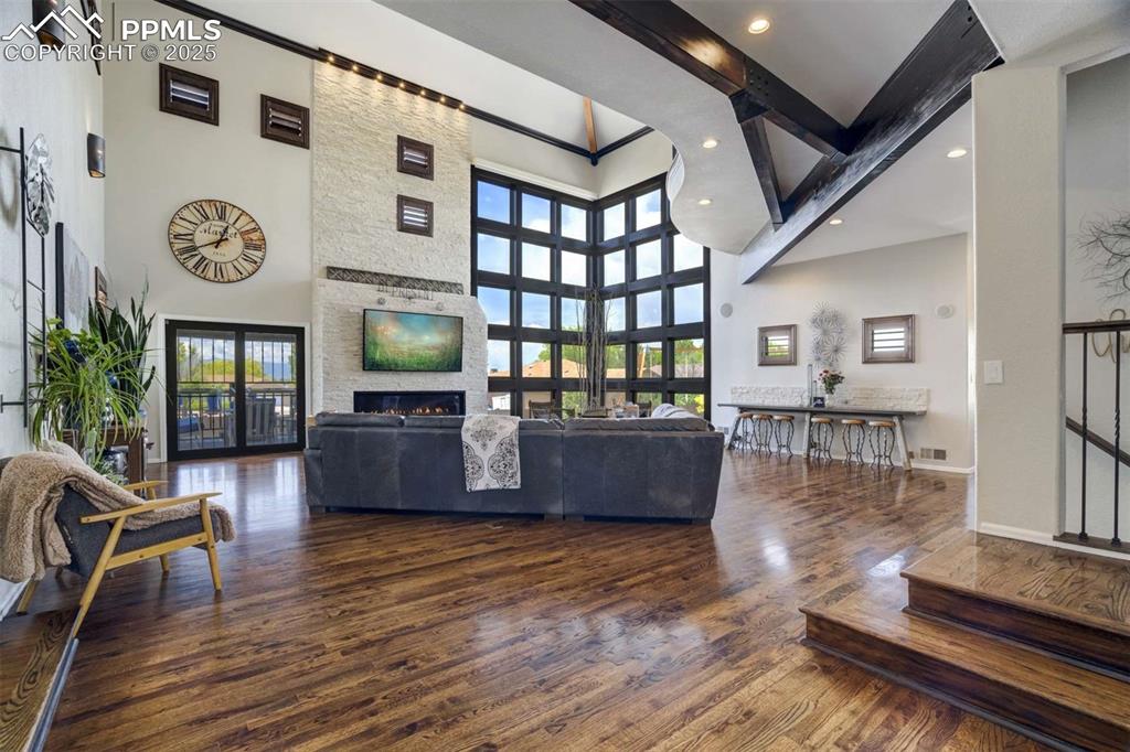 Image 3 of 50: Living area with dark wood finished floors, healthy amount of natural light