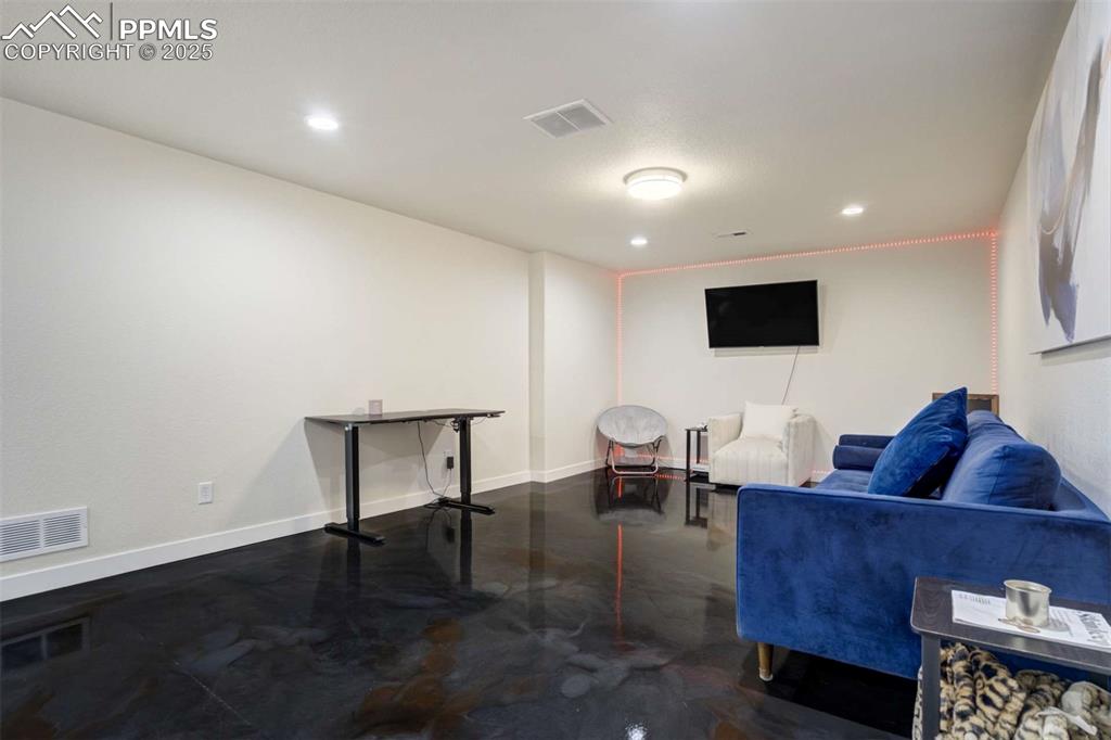 Image 31 of 50: Living area with baseboards and recessed lighting
