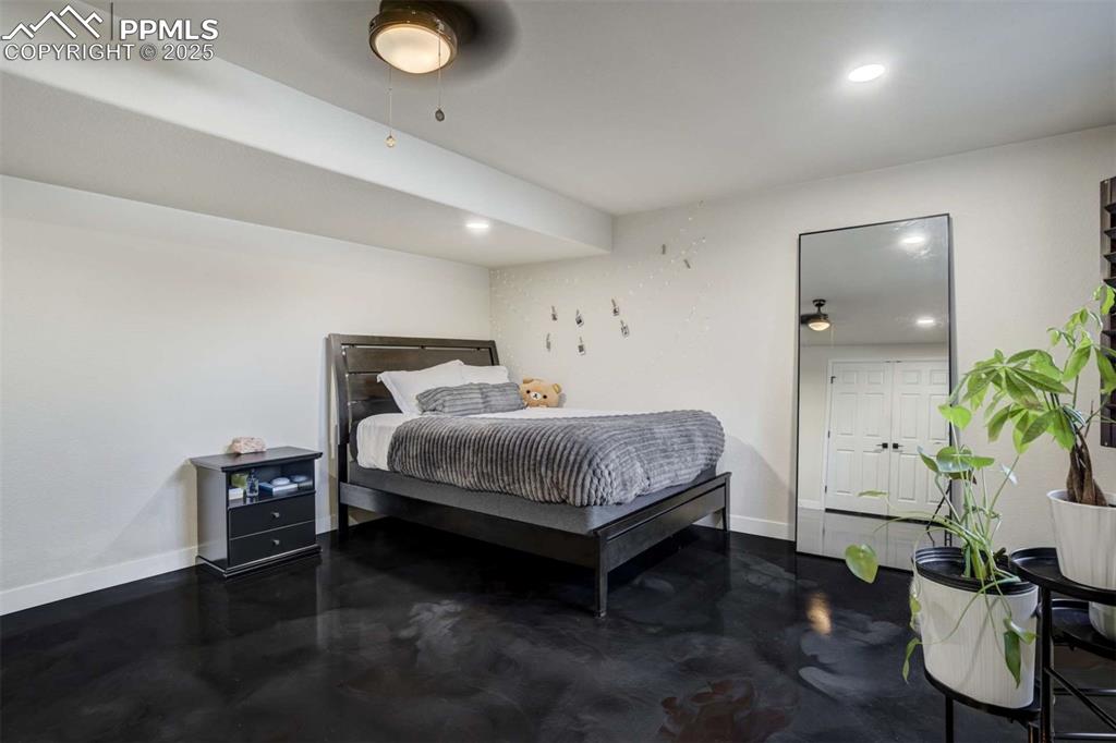 Image 37 of 50: Bedroom featuring recessed lighting and concrete flooring