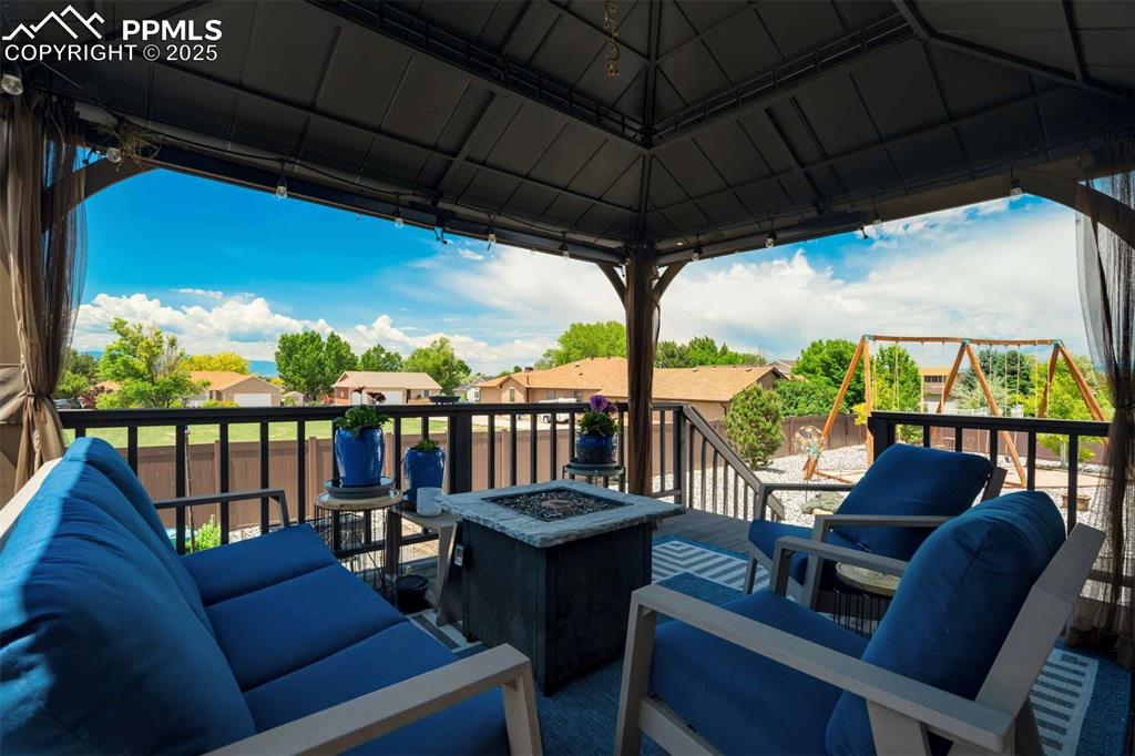 Image 40 of 50: View of wooden balcony featuring a wooden deck, a residential view, a sunro