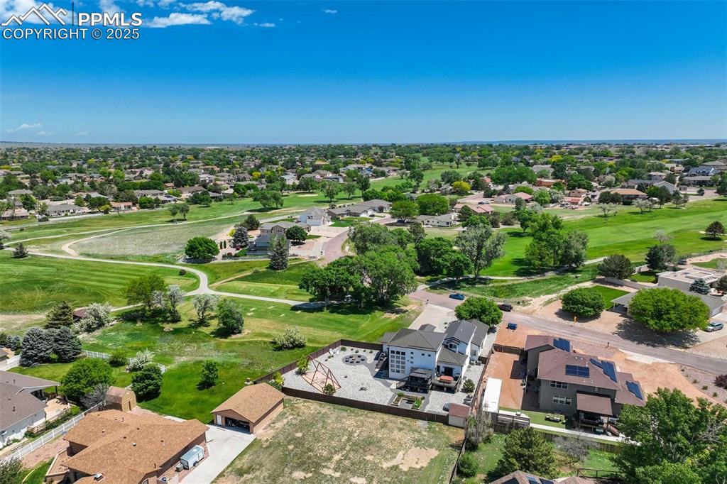 Image 45 of 50: Aerial view of residential area featuring a local golf course