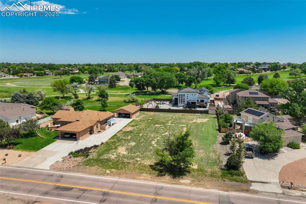 Image 46 of 50: Aerial view of residential area with a golf course