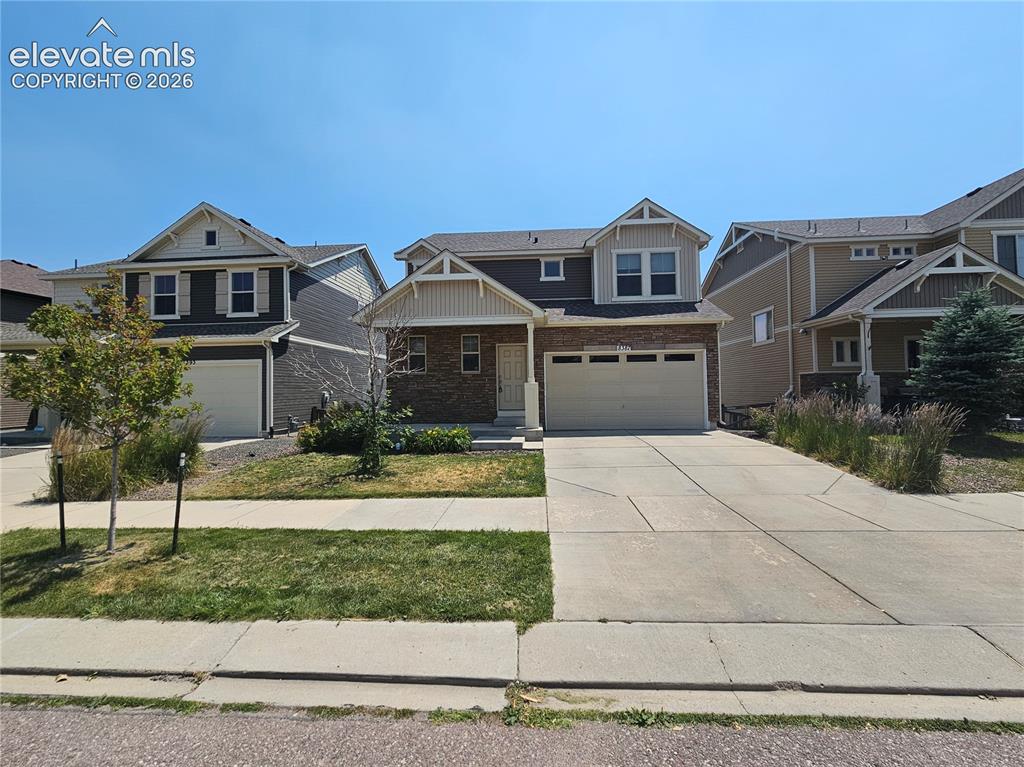 Caption: Two-story property featuring a mixed-material facade with stone accents and siding