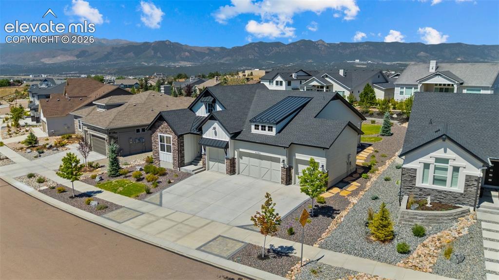 Image 1 of 32: Contemporary residence featuring a light-colored stucco and stone facade, a