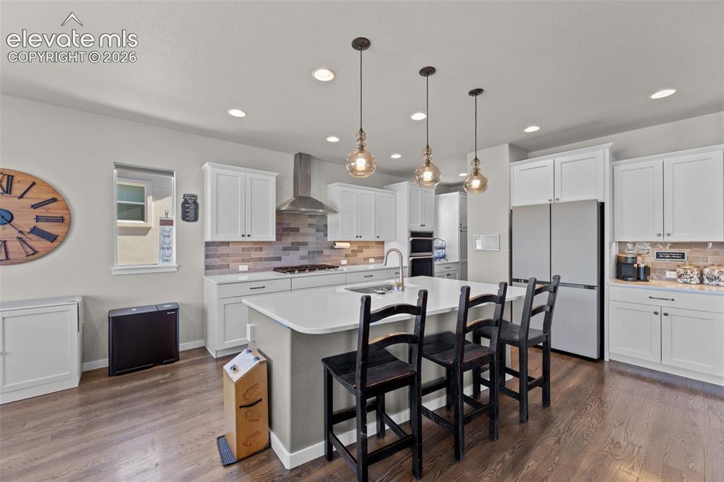 Image 11 of 32: Gourmet kitchen featuring white shaker cabinetry, stainless steel appliance