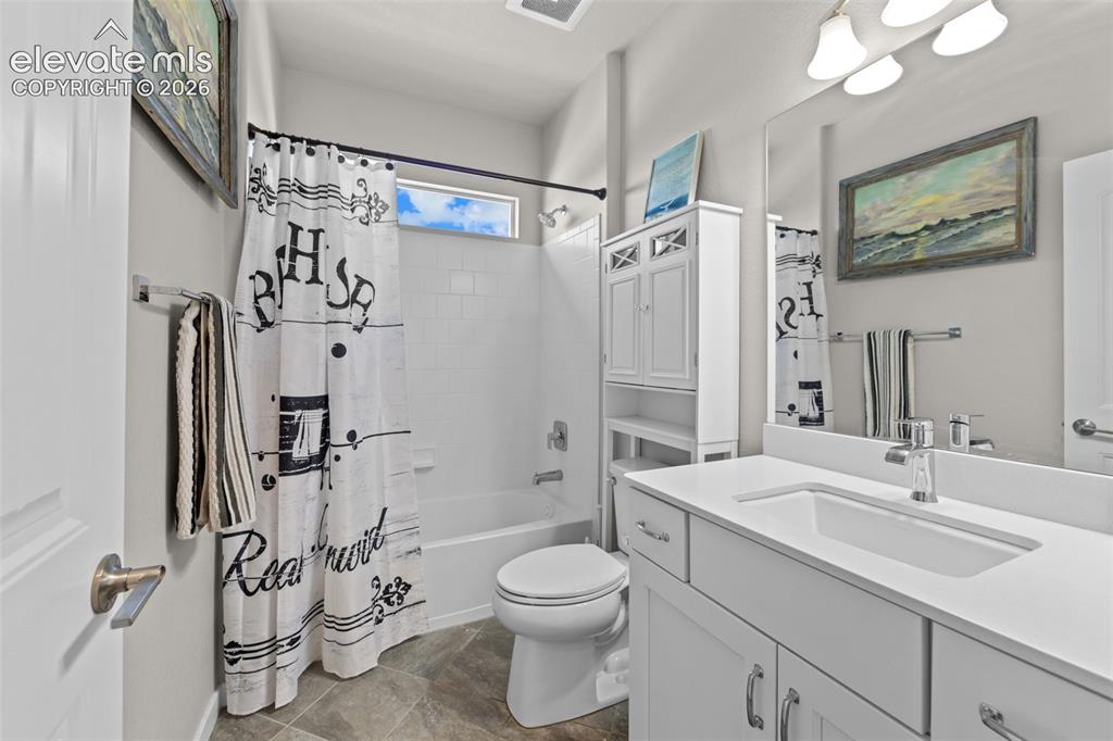 Image 15 of 32: Bathroom featuring a white vanity with an integrated sink, polished chrome