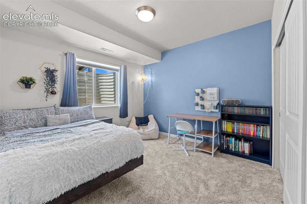 Image 20 of 32: Carpeted room featuring a wide egress window, recessed ceiling light, built