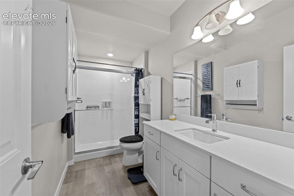 Image 22 of 32: Bathroom featuring a white vanity with an integrated sink and chrome faucet