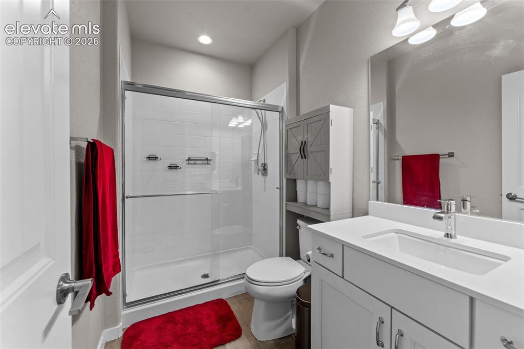 Image 24 of 32: Bathroom featuring a white vanity with a rectangular undermount sink, a lar