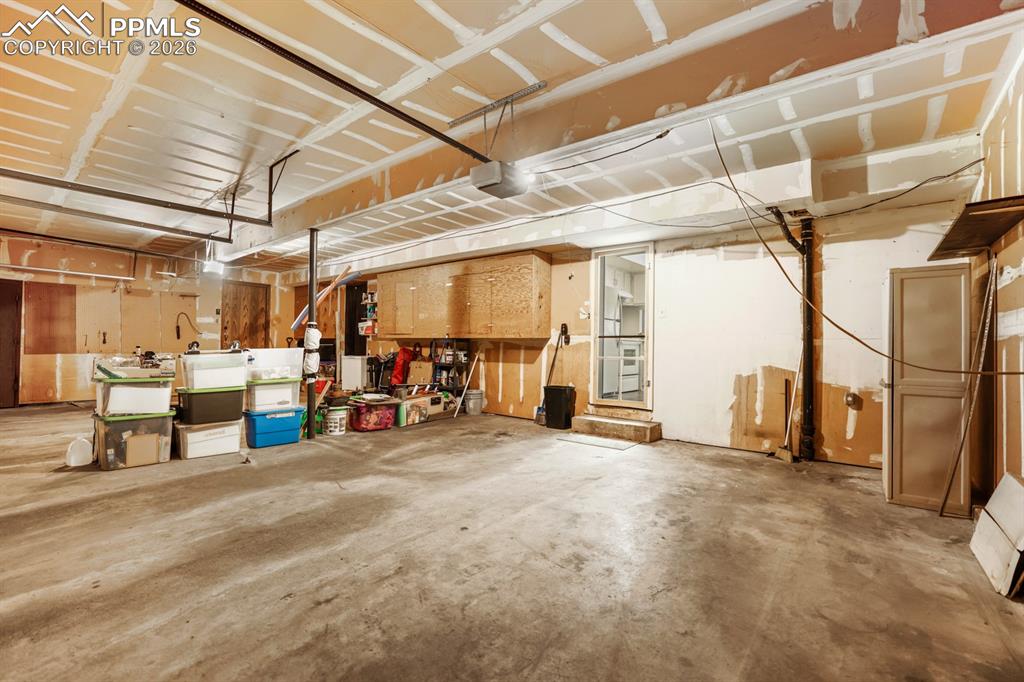 Image 25 of 28: Attached shared garage with door opener.