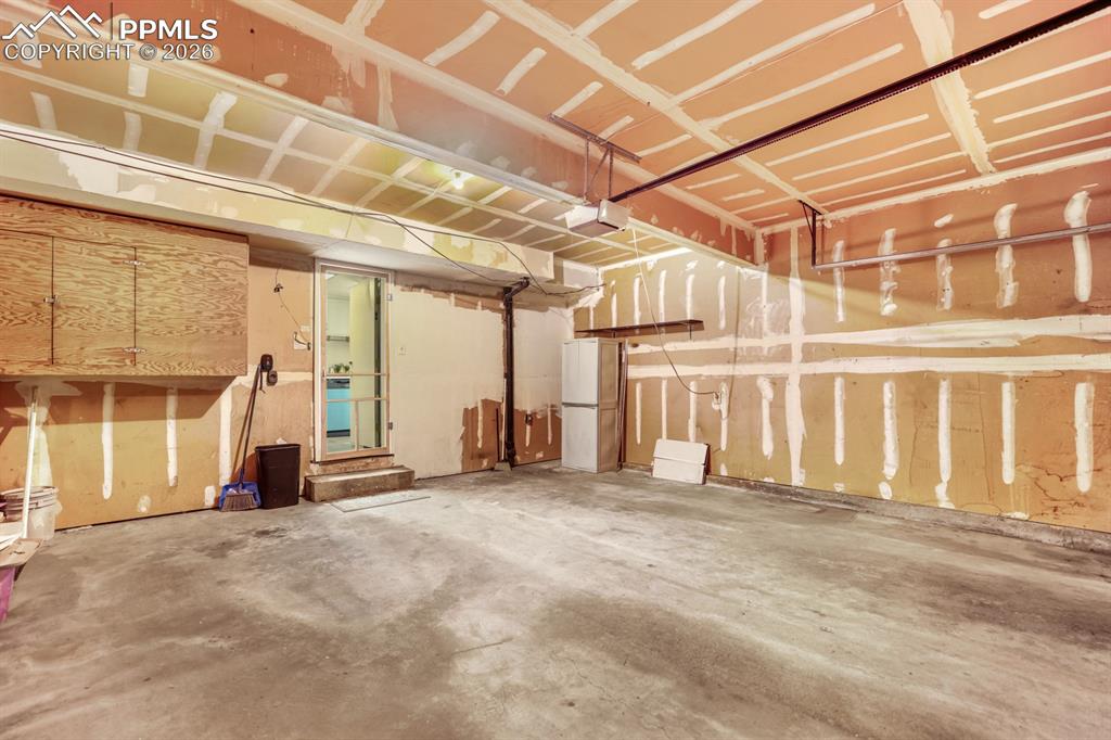 Image 26 of 28: Assigned 1-car space with entrance into the kitchen.