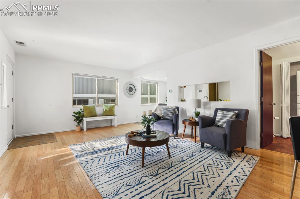 Image 4 of 28: The spacious living room has a warm & inviting atmosphere perfect for gathe