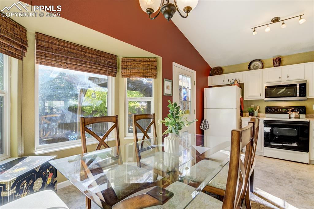 Image 11 of 50: Bright dining space flows seamlessly between kitchen + great room.