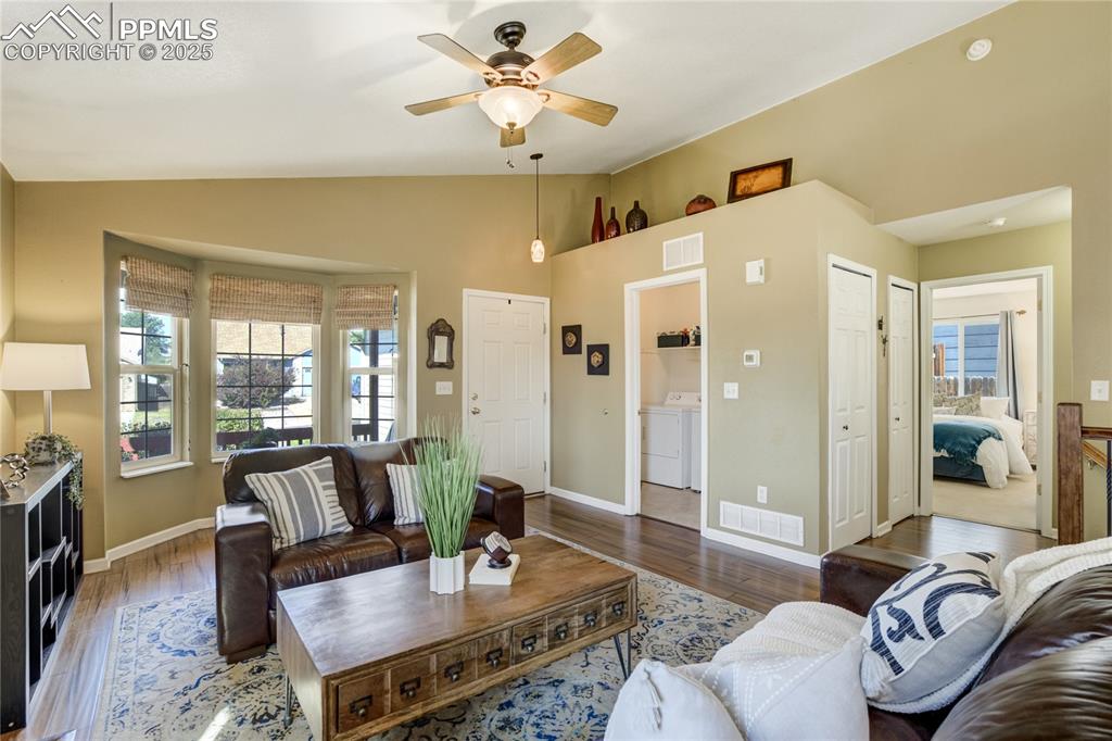 Image 8 of 50: Soaring vaulted ceilings + walls of windows fill the great room with natura