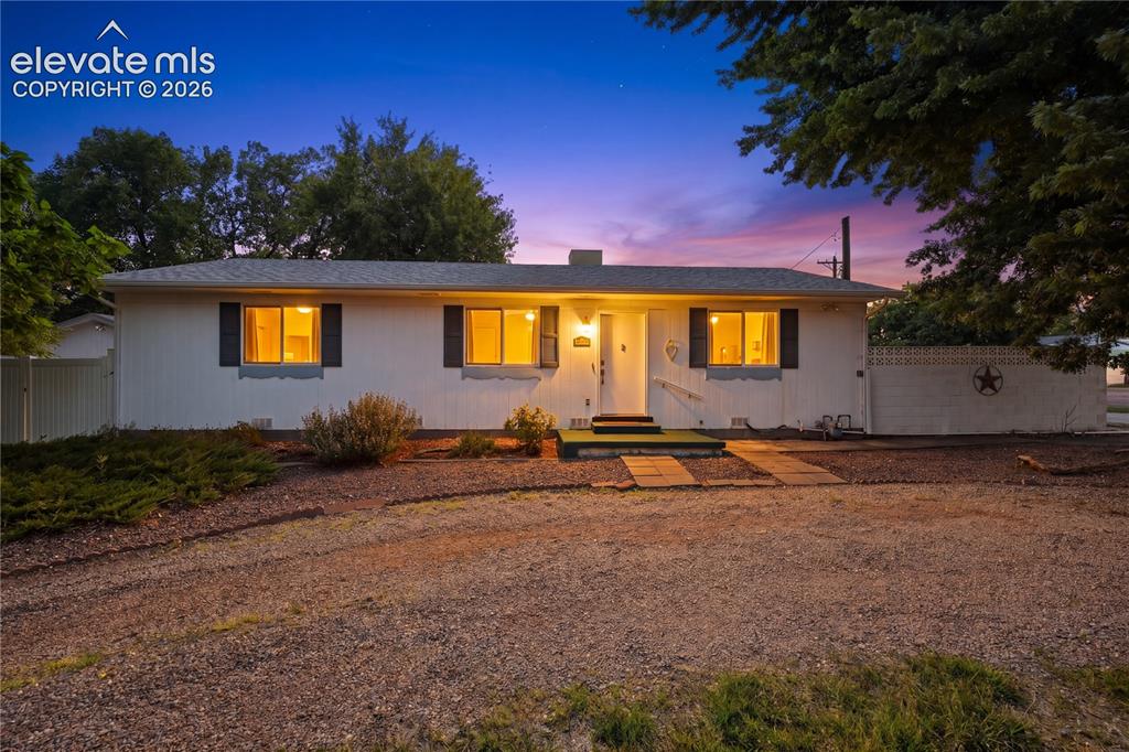 Image 1 of 27: Welcoming Home, front exterior with clean lines, mature shade trees, and lo