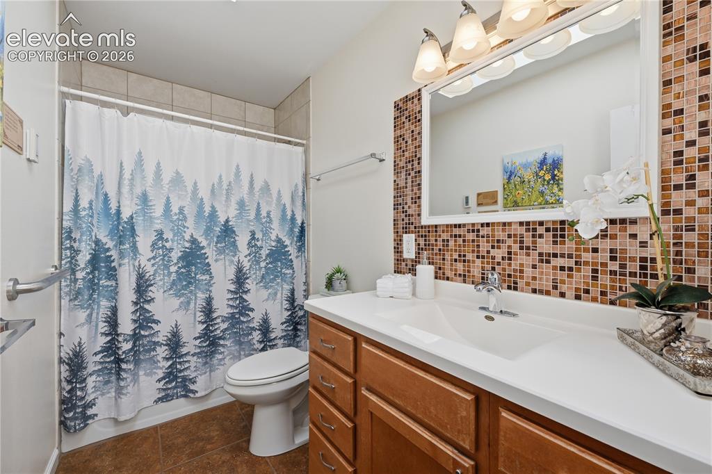 Image 12 of 27: Full bathroom offers a functional layout with generous vanity space and att