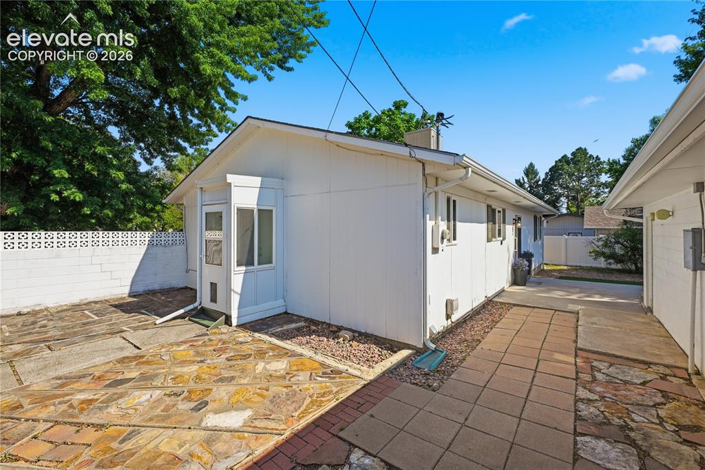 Image 19 of 27: Charming side entry and private courtyard area add character while creating