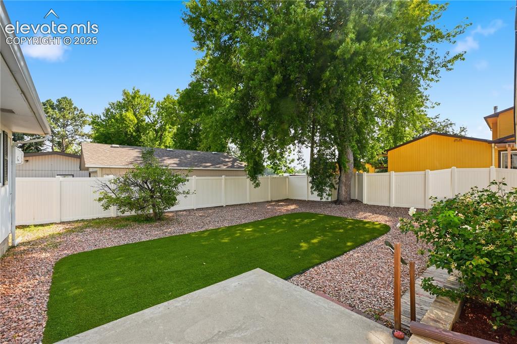 Image 20 of 27: Turf yard w privacy vinyl fencing