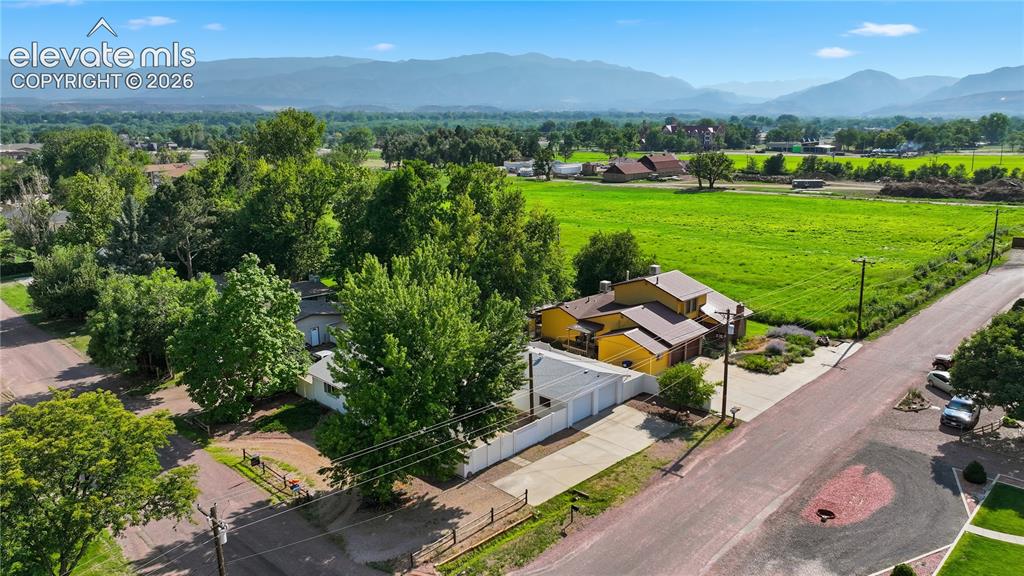Image 22 of 27: Aerial view highlights the home’s setting in an established neighborhood ne
