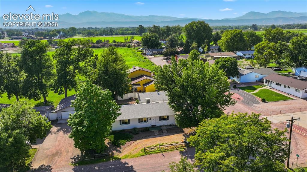 Image 23 of 27: Aerial view highlights the home’s setting in an established neighborhood ne