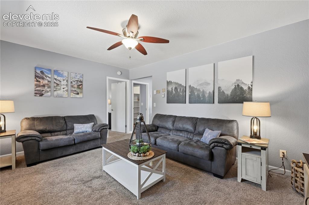 Image 4 of 27: Comfortable living room with soft natural light, neutral tones, and an invi