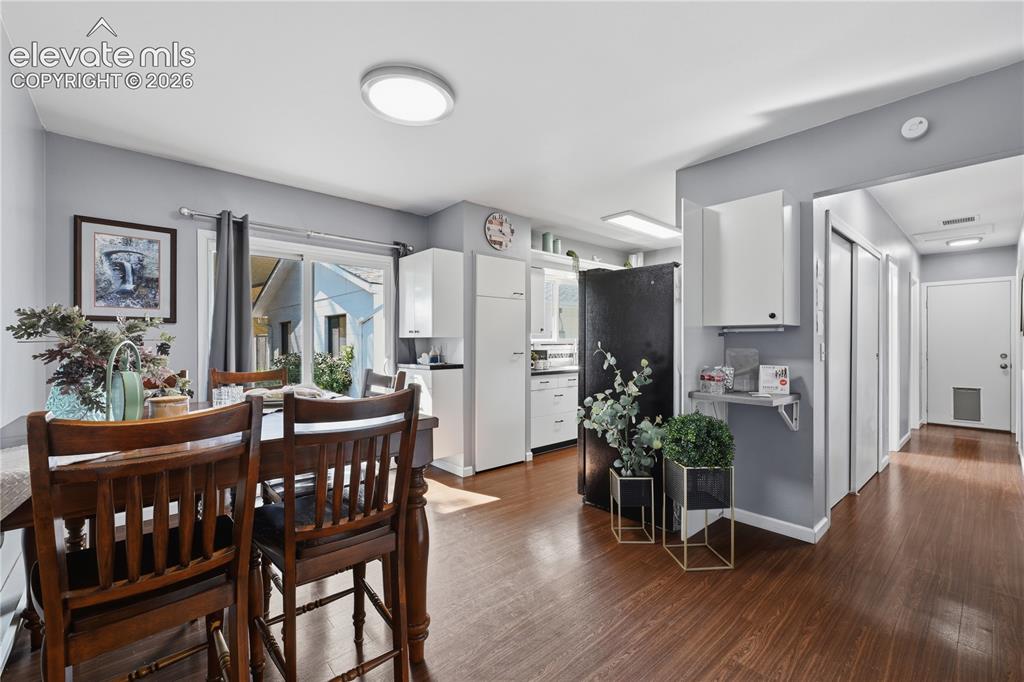 Image 5 of 27: Bright dining area flows easily into the kitchen and living spaces, creatin