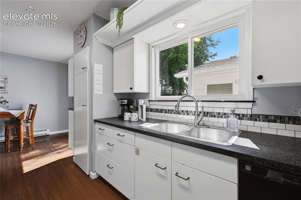 Image 6 of 27: Modern galley style IKEA kitchen offers clean lines, generous cabinetry, an