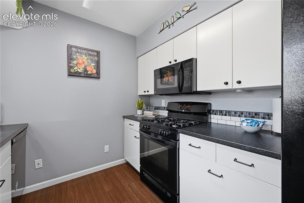 Image 7 of 27: Updated kitchen with crisp cabinetry, sleek finishes, and a fresh, modern f