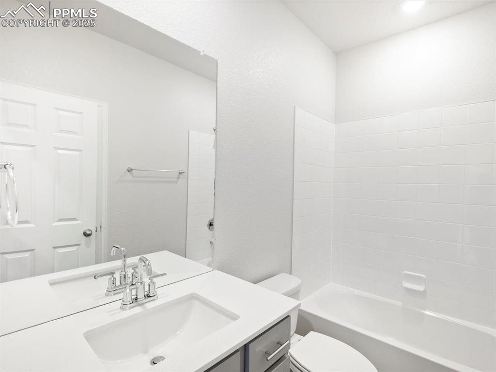 Image 11 of 19: Bathroom featuring vanity and shower / washtub combination