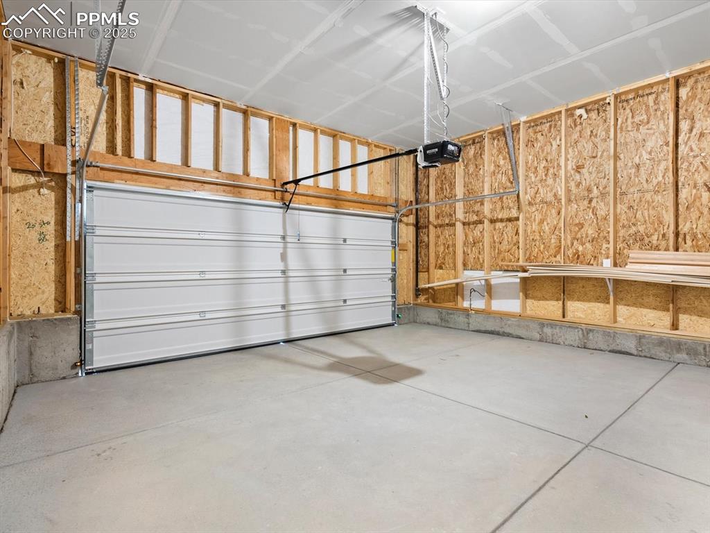 Image 18 of 19: Garage featuring a garage door opener