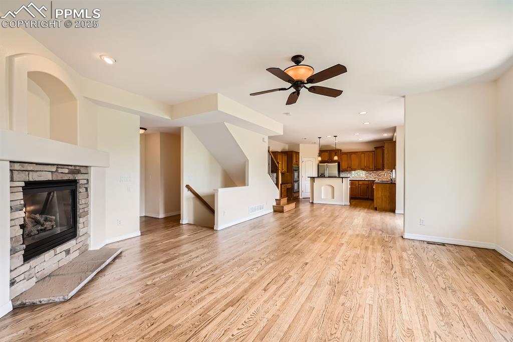 Image 14 of 48: Great room, stone surround fireplace